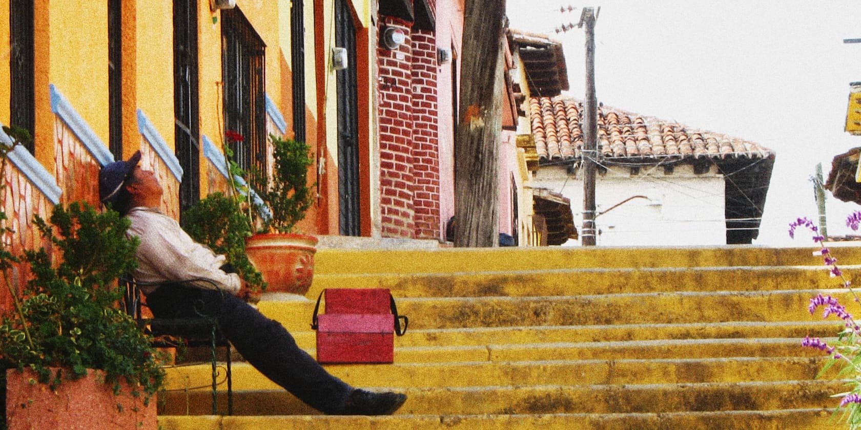 a man sleeping on a set of yellow stairs